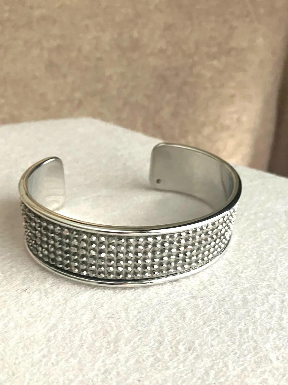 Silver cuff studded with metallic rhinestones